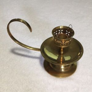 Solid brass single taper candle holder with swirl handle. Cut work at top